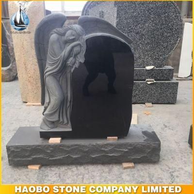 Black Granite Leaning Angel Carved with Flowers Headstone